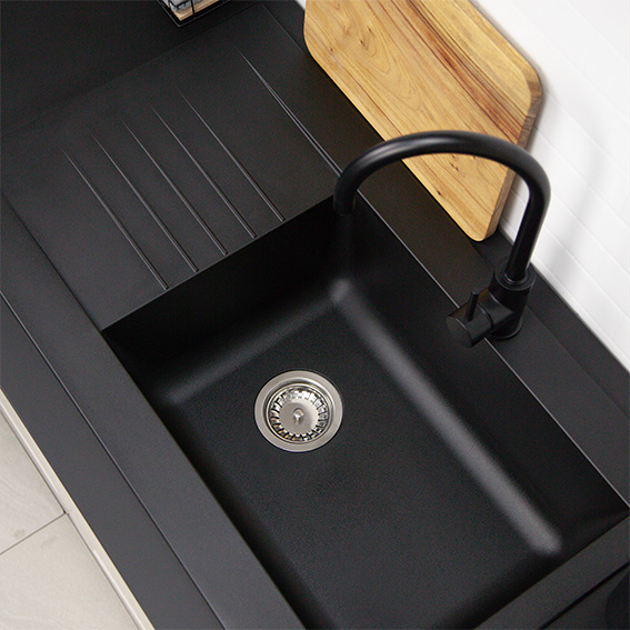 A high-quality single bowl composite kitchen sink with a matte black finish.
